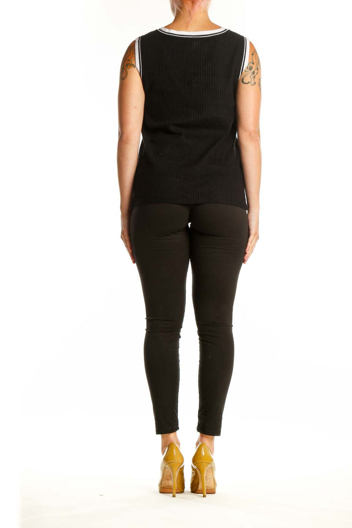 Black ribbed V-neck knit tank with white contrast trim, back view on model