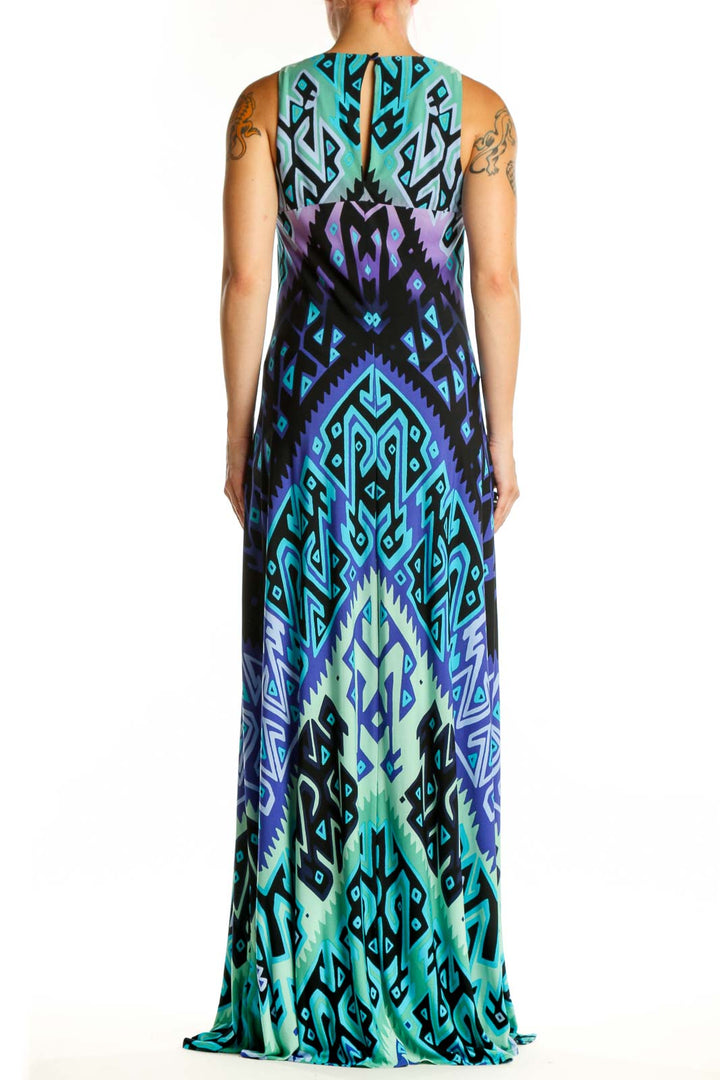 Back view of blue geometric maxi tank dress showing flowing silhouette and continuous geometric pattern