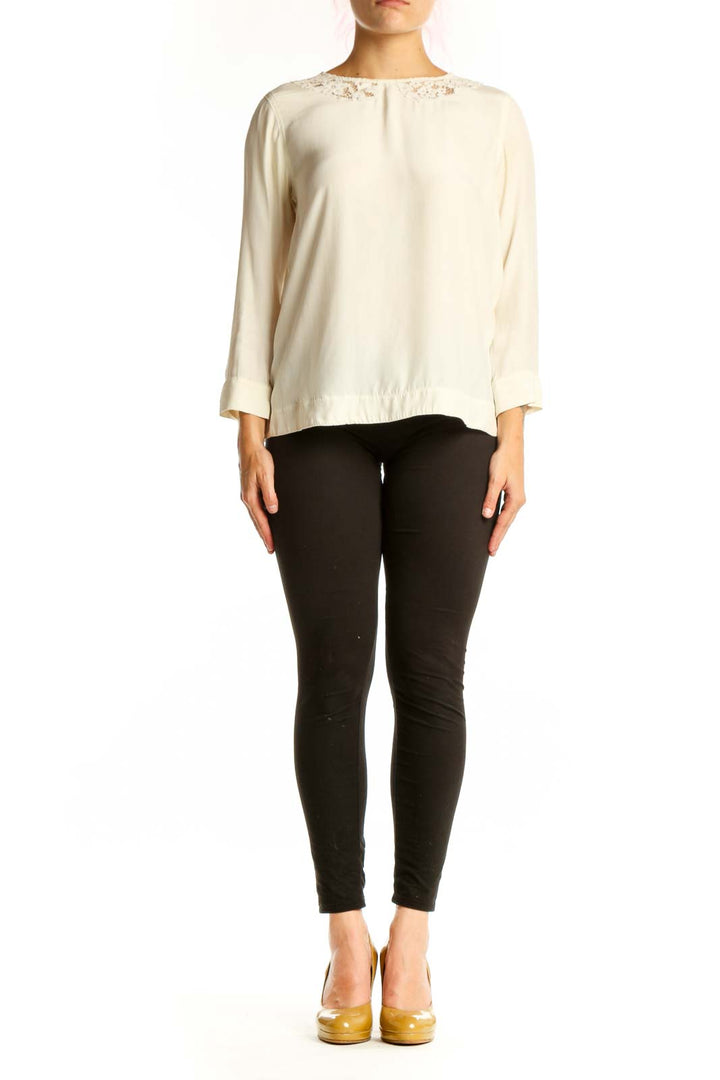 Cream Sandro blouse with lace shoulder trim and three-quarter sleeves, front view