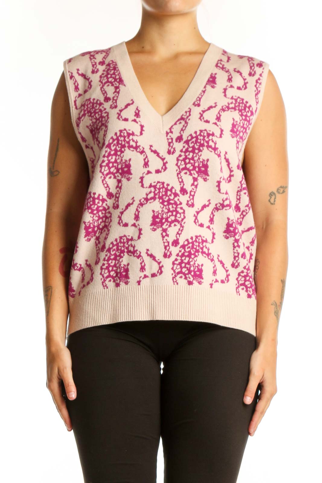 Front view of pink elephant print knit vest with V-neckline and cream background