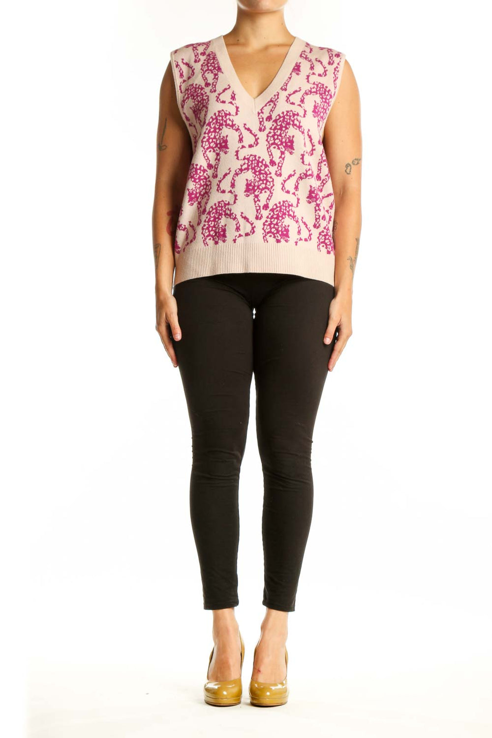 Front view of pink elephant print knit vest with V-neckline and cream background