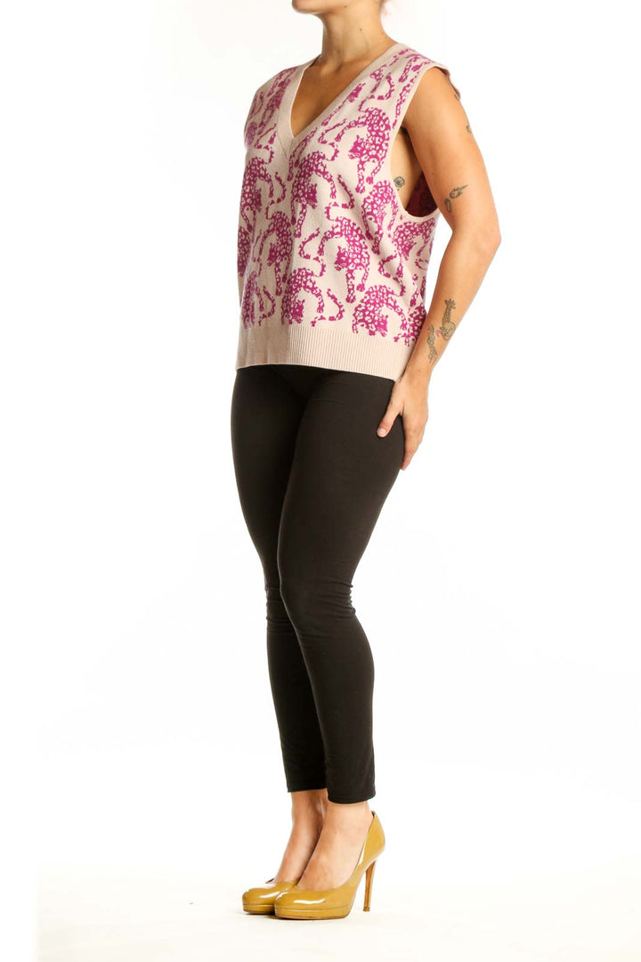 Front view of pink elephant print knit vest with V-neckline and cream background