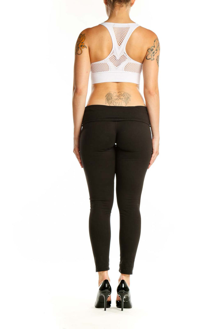 White mesh cutout sports bra with racerback design, back view on model