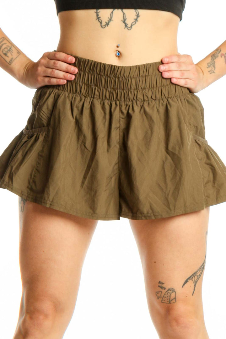 Olive green ruched athletic skirt with elastic waistband, front view showing flowy design and gathered construction