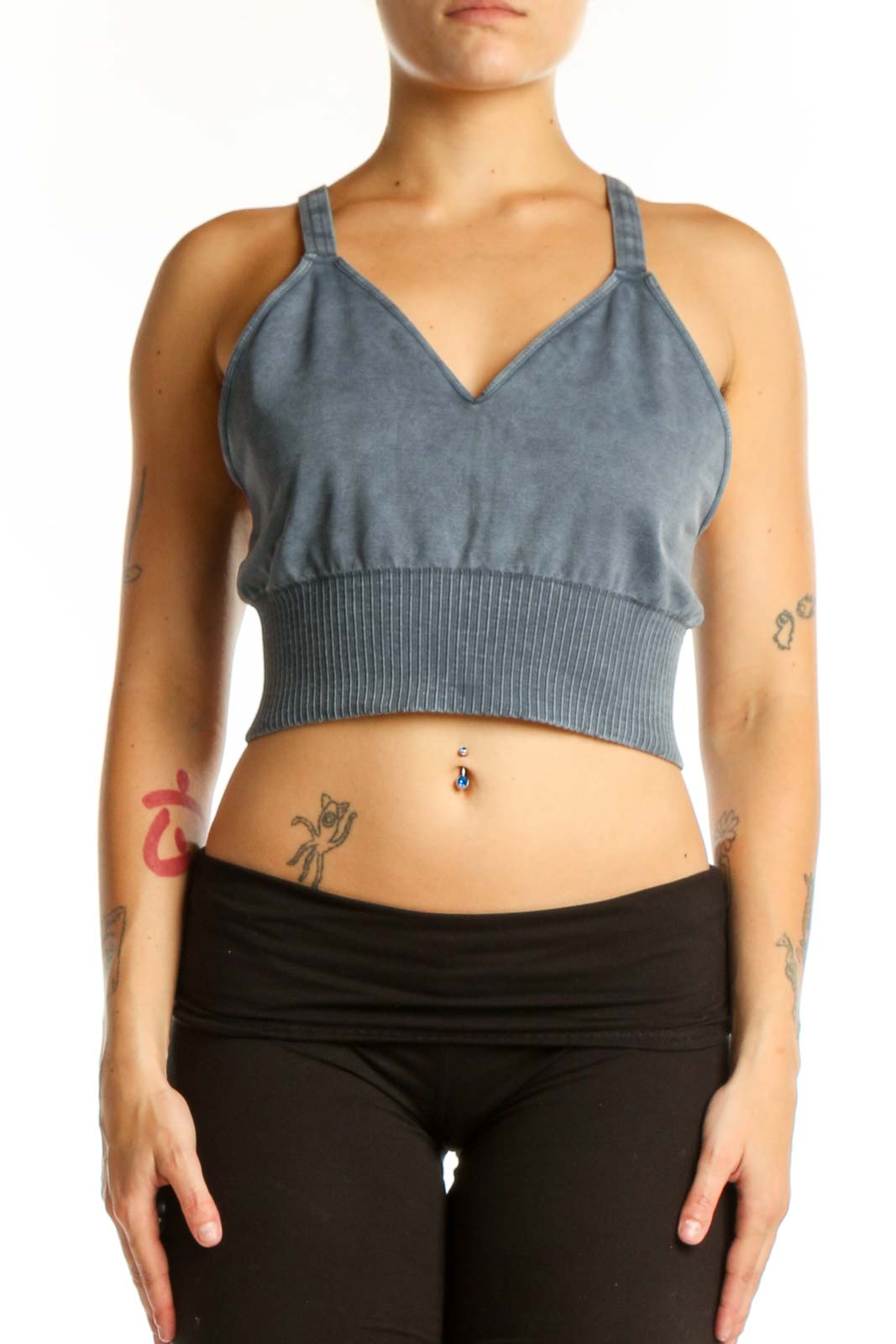 Blue ribbed crop tank top with V-neckline and adjustable straps, front view on model