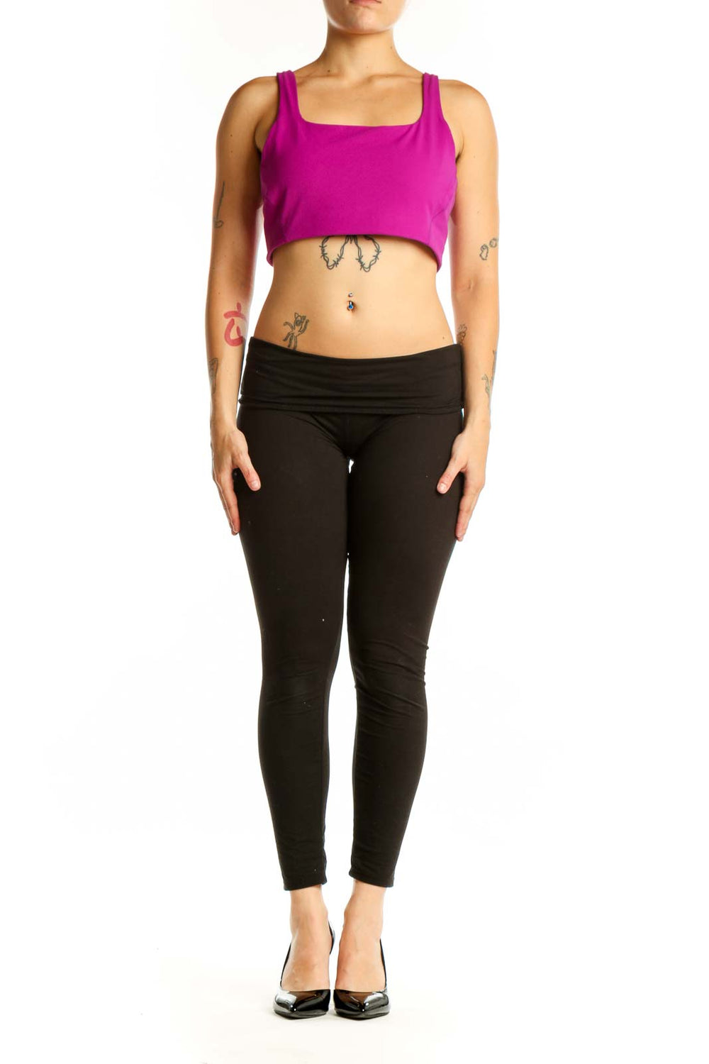 Woman wearing magenta square neckline sports bra with black leggings, front view