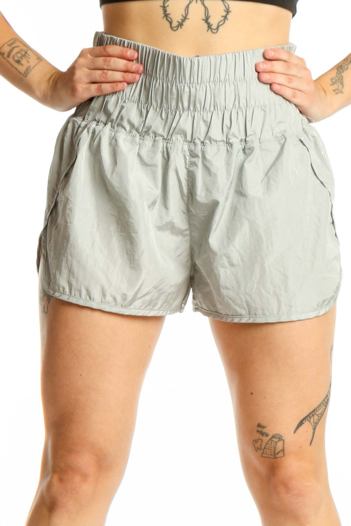 Sage green elastic waist athletic shorts front view on model