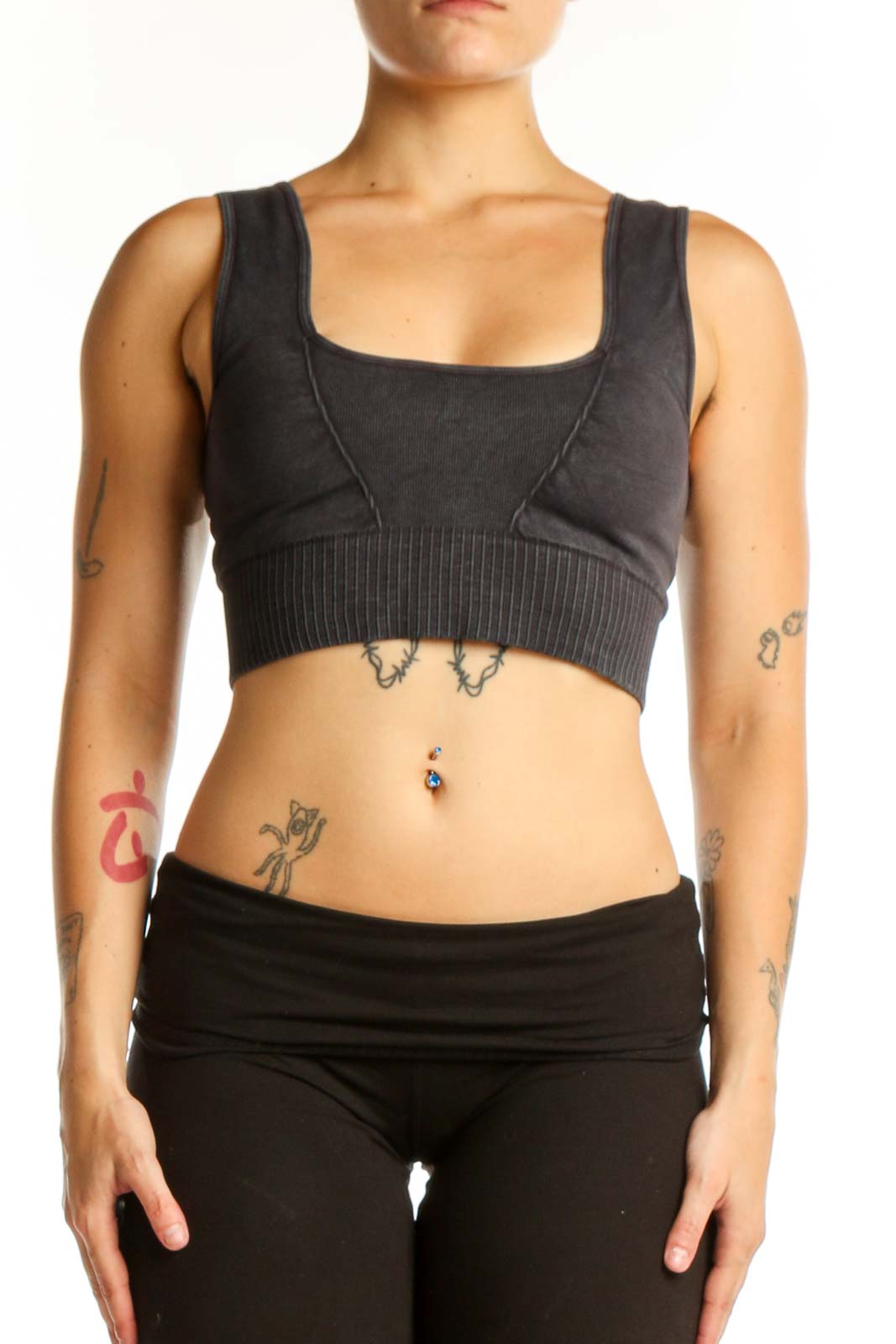 Black ribbed sports bra with square neckline and thick straps, front view on model
