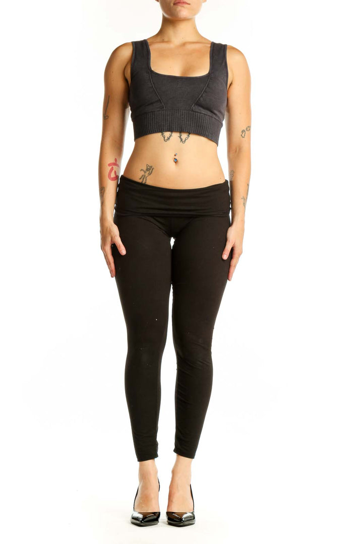 Black ribbed sports bra with square neckline and thick straps, front view on model