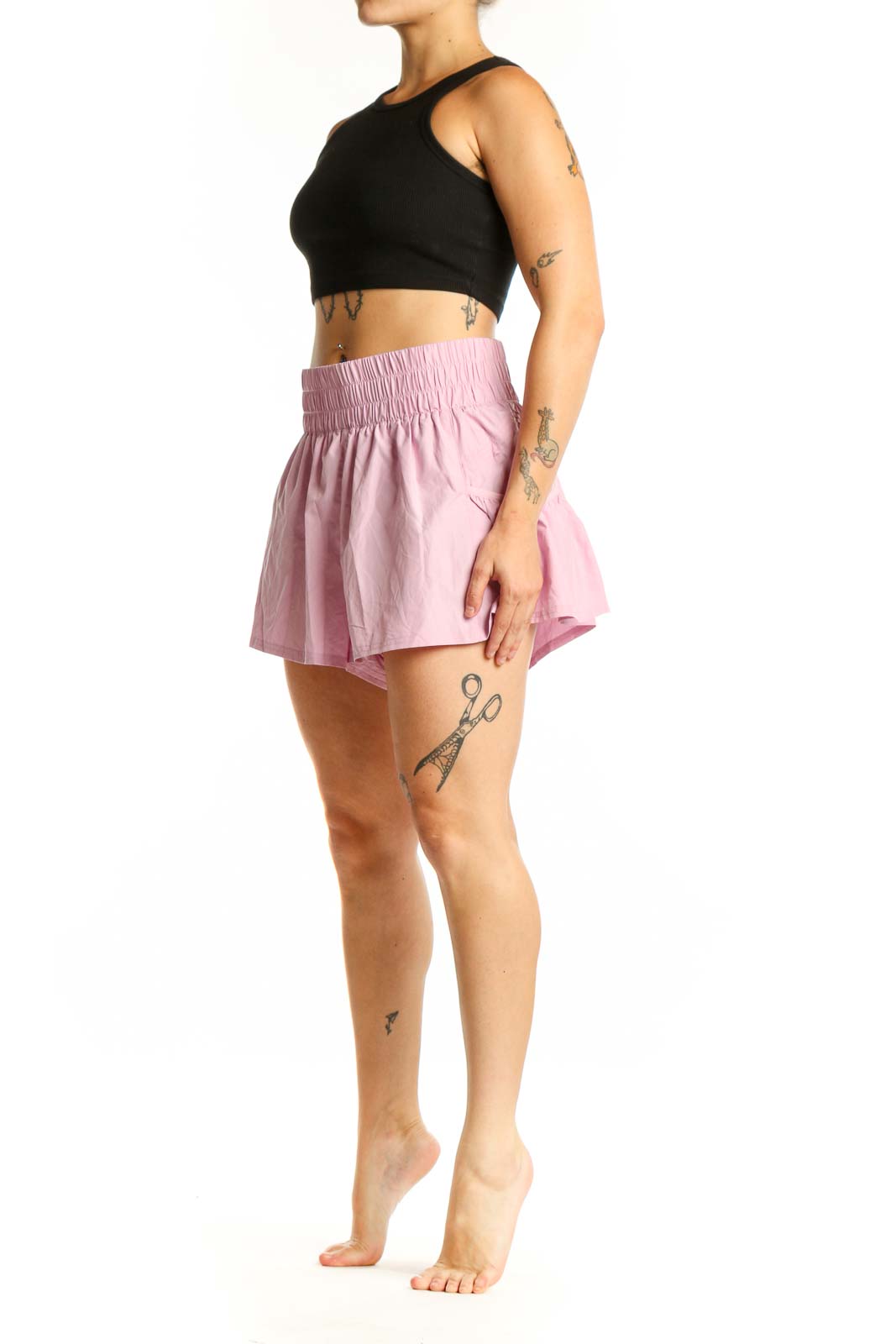 Pink pleated athletic skirt with smocked waistband, front view on model