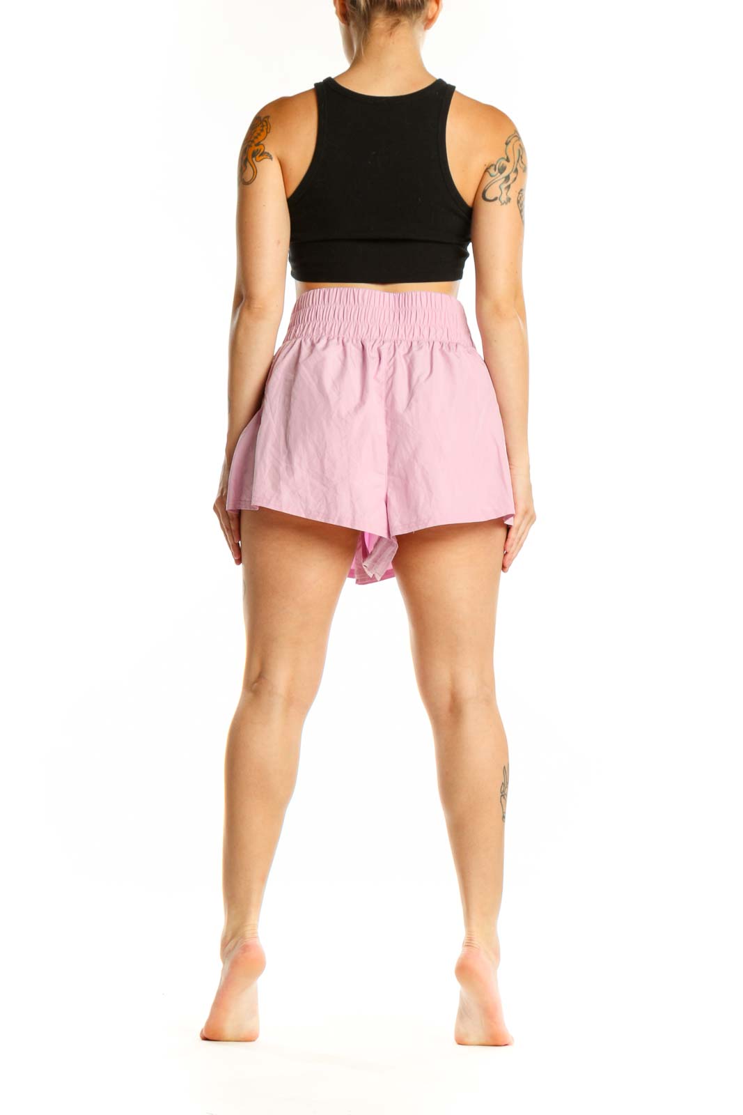 Pink pleated athletic skirt back view, showing voluminous silhouette and fit
