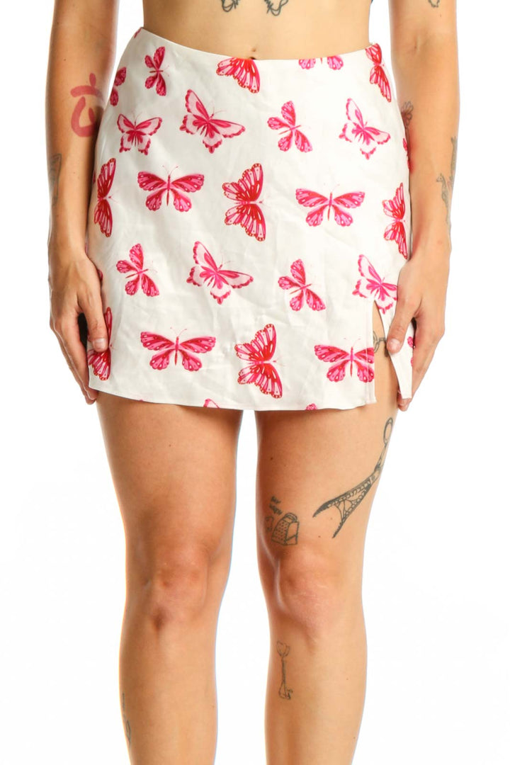 Cream mini skirt with pink and red butterfly print, front view, worn with black crop top