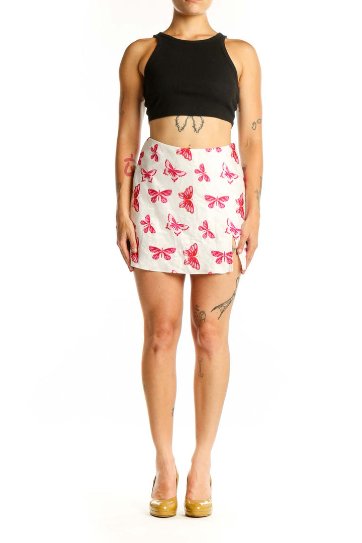 Cream mini skirt with pink and red butterfly print, front view, worn with black crop top