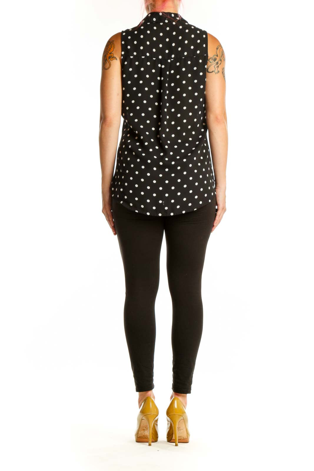 Black sleeveless button-up blouse with white polka dot pattern, back view