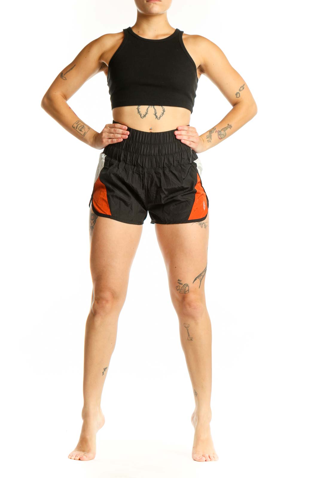 Black and orange colorblock athletic shorts with high-waisted ruched waistband and side pockets, front view