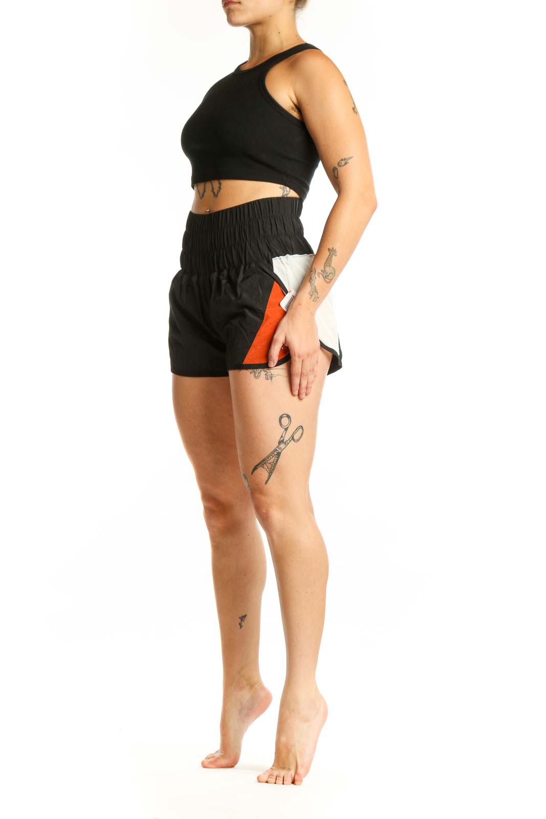 Black and orange colorblock athletic shorts with high-waisted ruched waistband and side pockets, front view