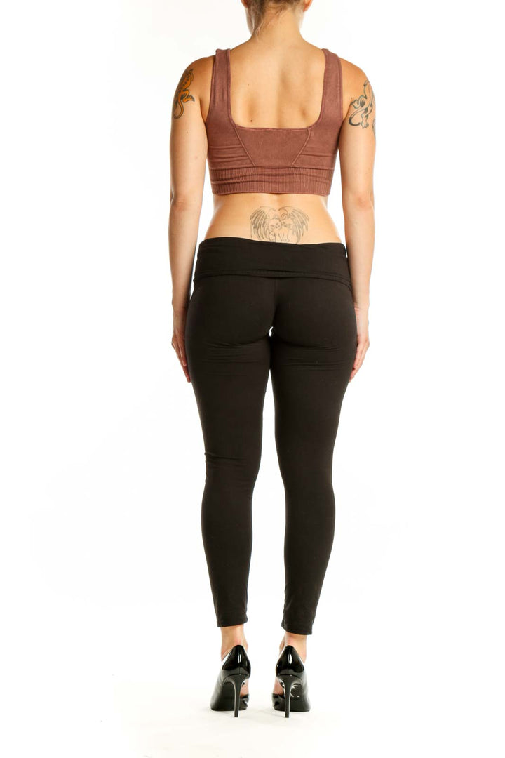 Burgundy ribbed sports bra with square neckline and black leggings, back view