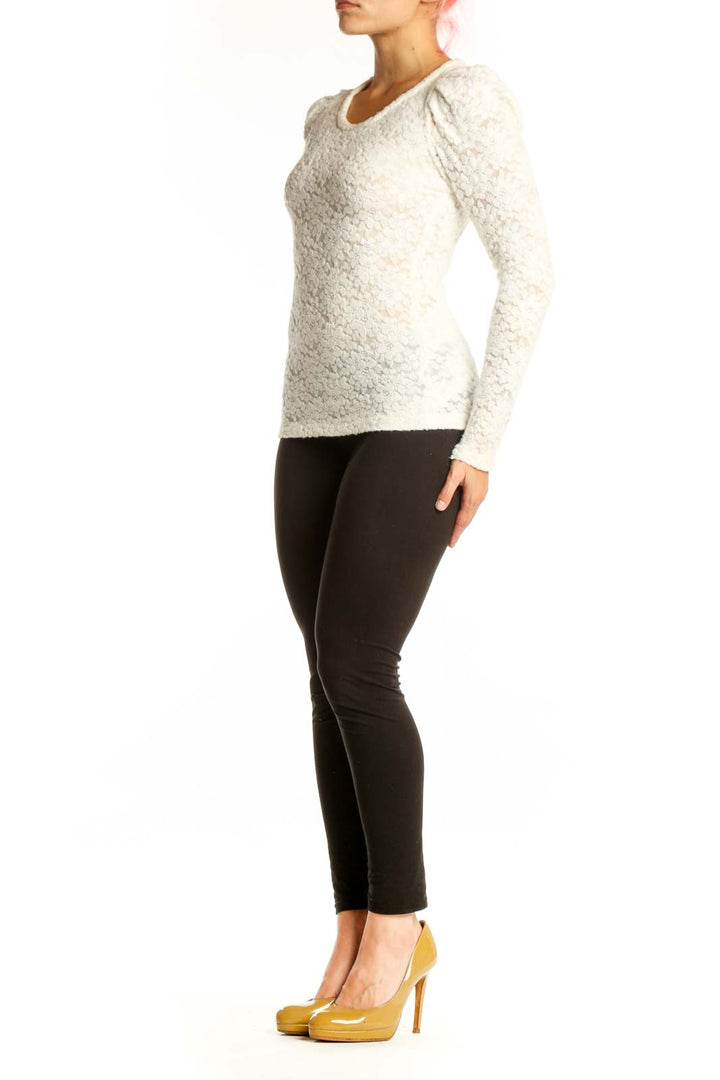 Maje cream textured knit top with puff sleeves, crew neckline, and fitted silhouette on model