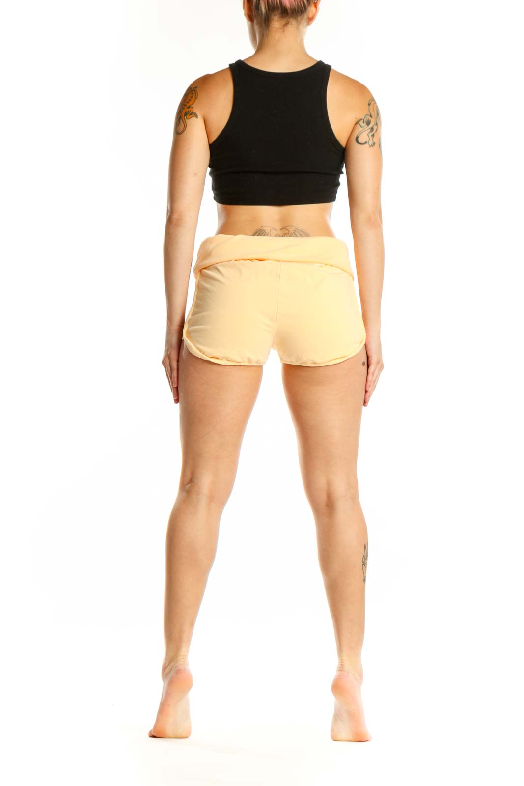 Yellow cotton activewear shorts with ruched sides, back view on model