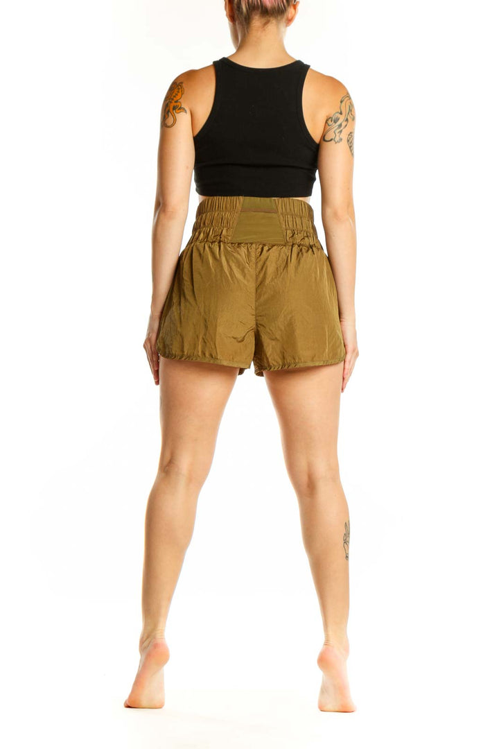 Olive nylon activewear shorts with functional side pockets and relaxed fit, side view