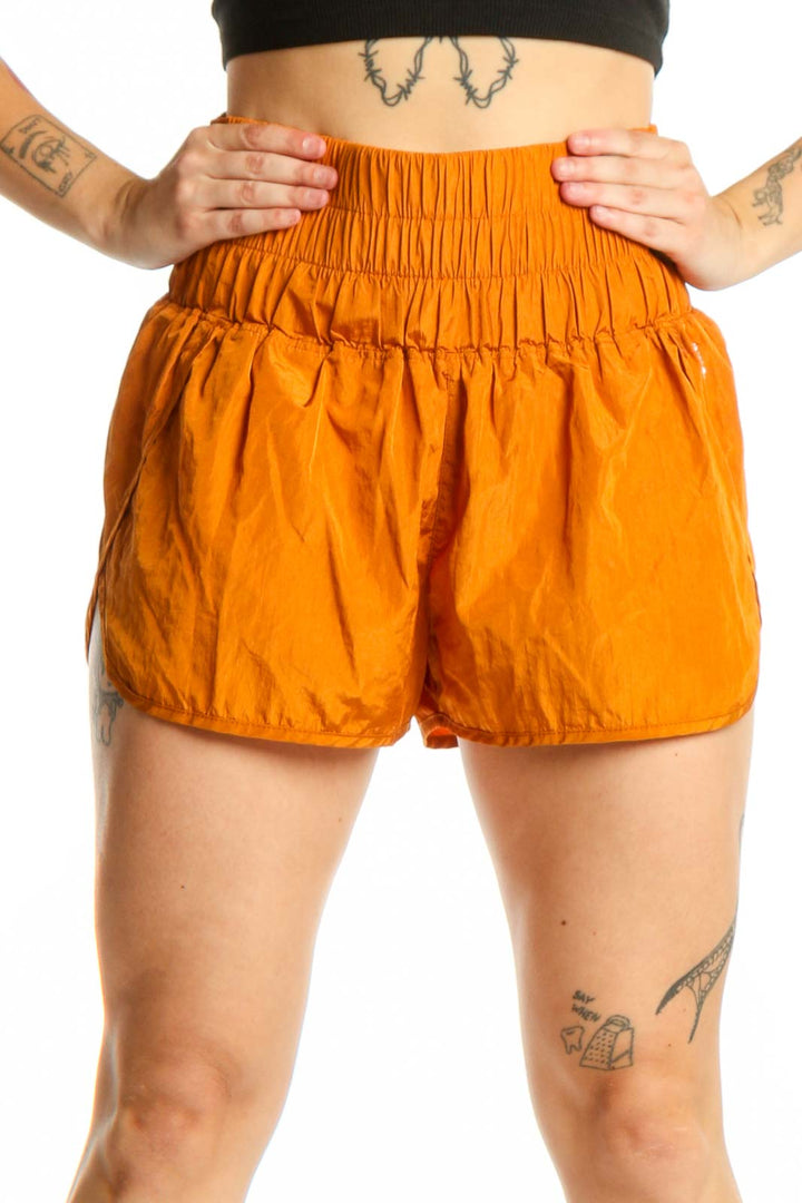 Front view of orange bubble shorts with high-waisted elasticated waistband and gathered hem detail