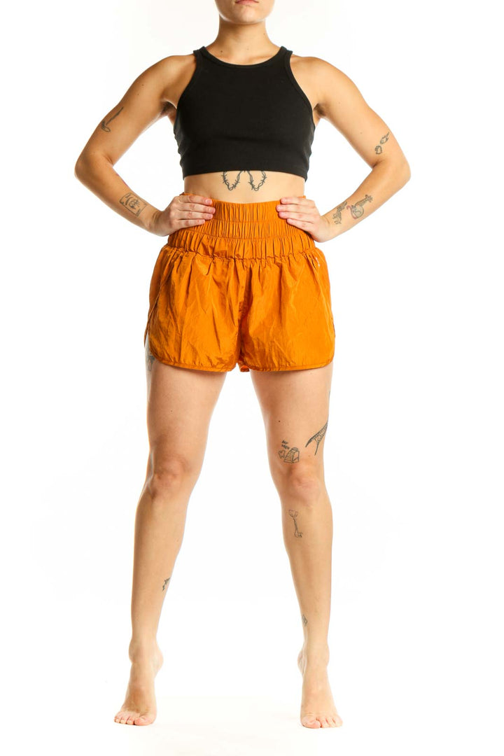 Front view of orange bubble shorts with high-waisted elasticated waistband and gathered hem detail