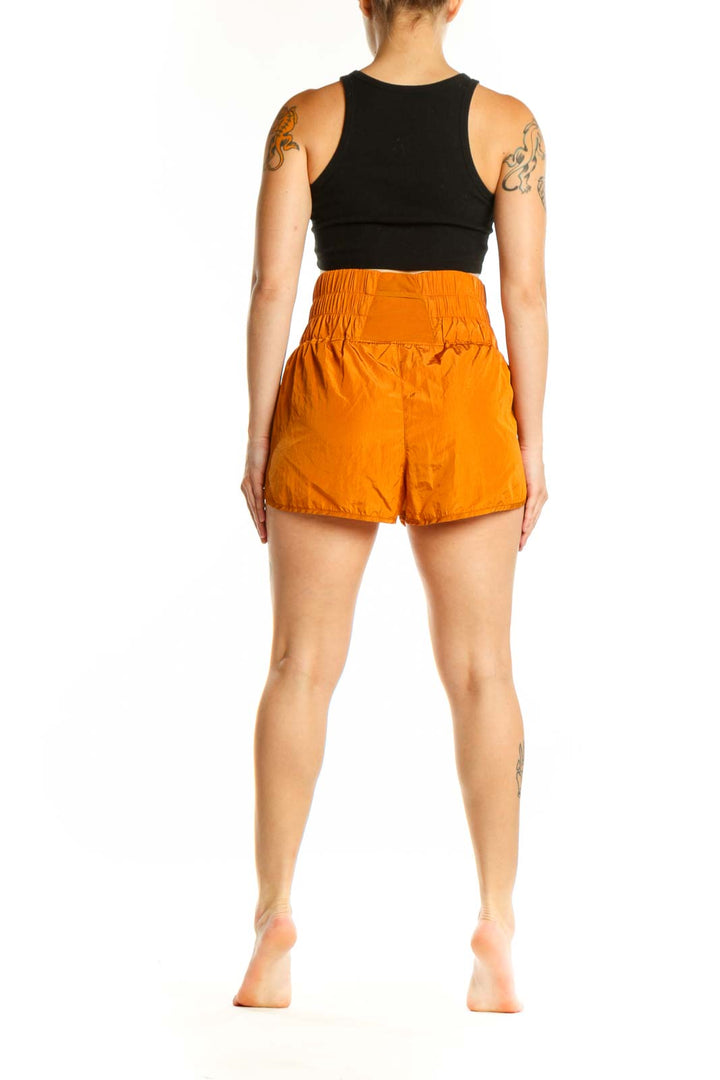 Back view of orange bubble shorts showing the voluminous bubble hem silhouette and relaxed fit
