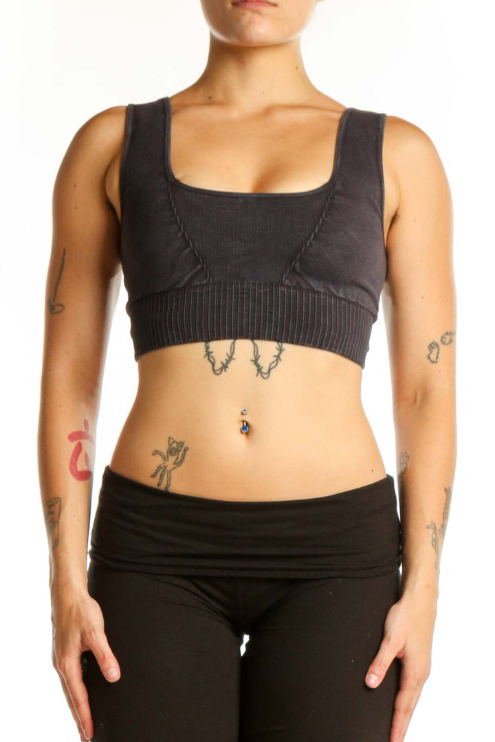 Black ribbed sports bra with square neckline and thick straps, front view on model