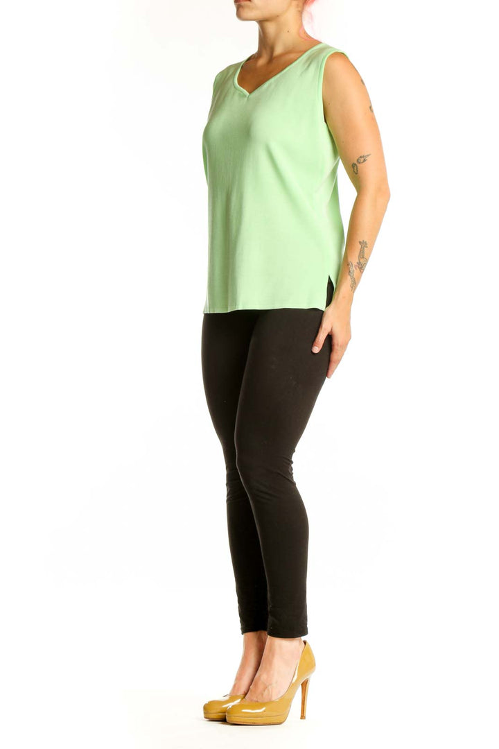 Green v-neck sleeveless knit tank top by MING WANG, front view on model