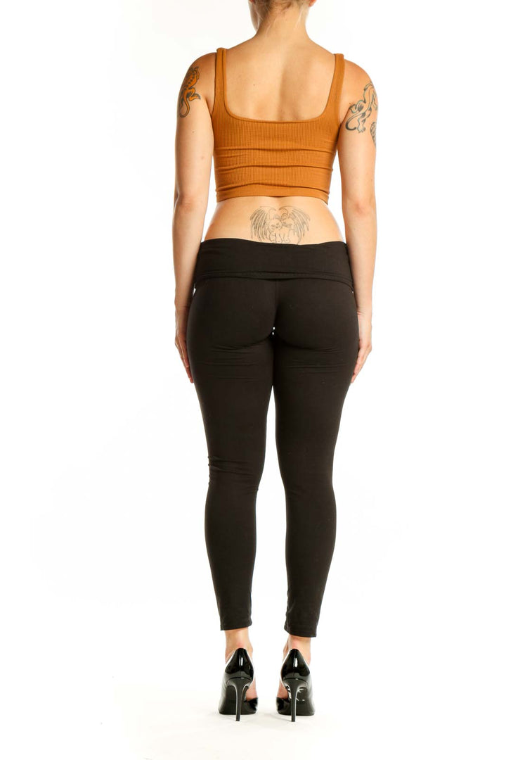 Orange ribbed crop tank top back view, showing fitted crop length design