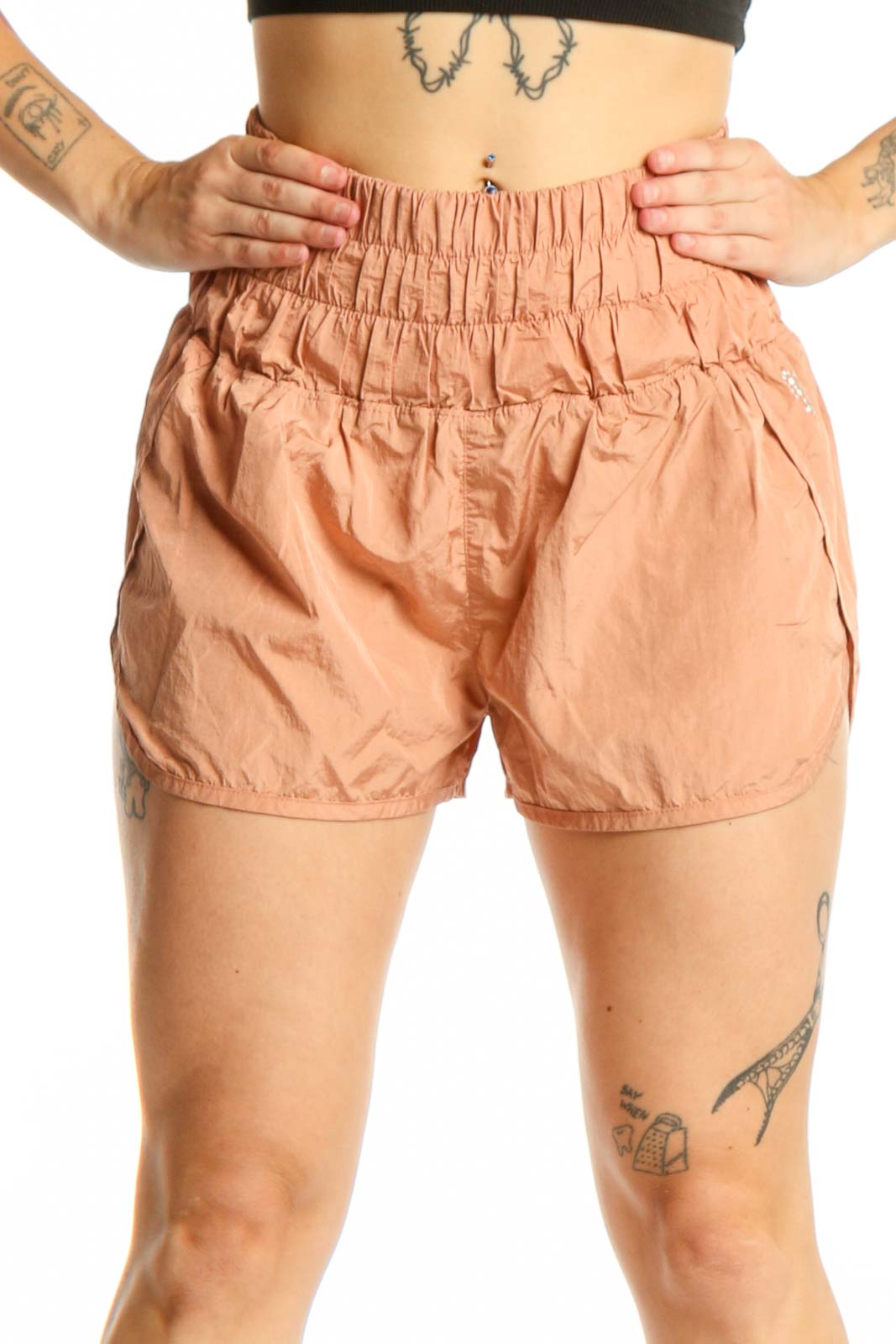 Peach high-waisted athletic shorts with elasticated waistband, front view on model
