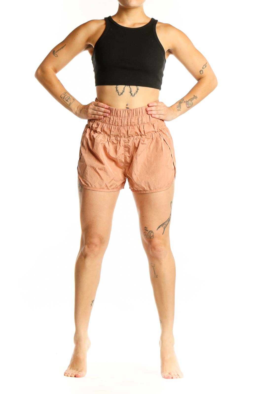 Peach high-waisted athletic shorts with elasticated waistband, front view on model