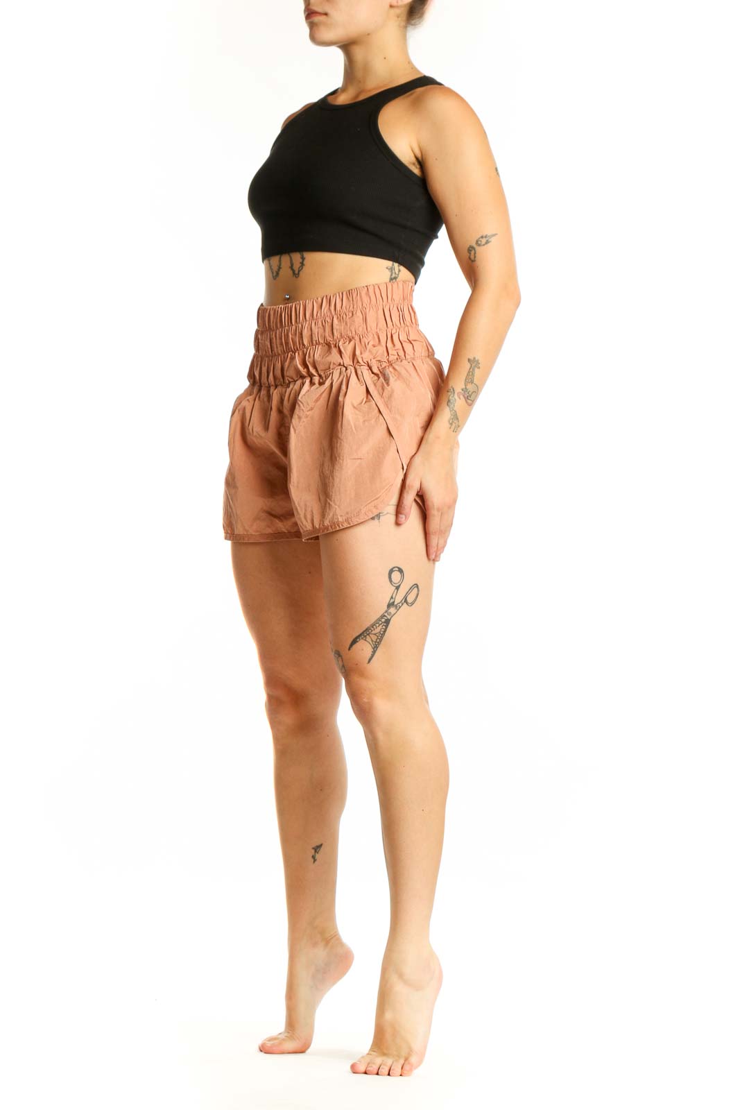 Peach high-waisted athletic shorts with elasticated waistband, front view on model
