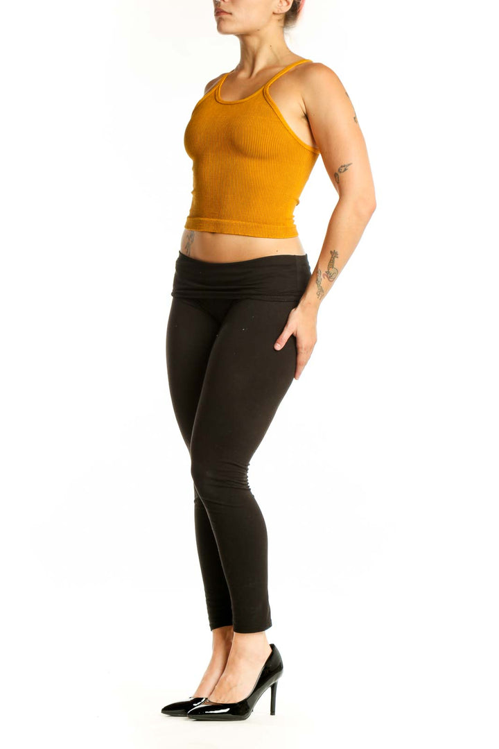 Gold ribbed crop tank top with spaghetti straps, front view on model