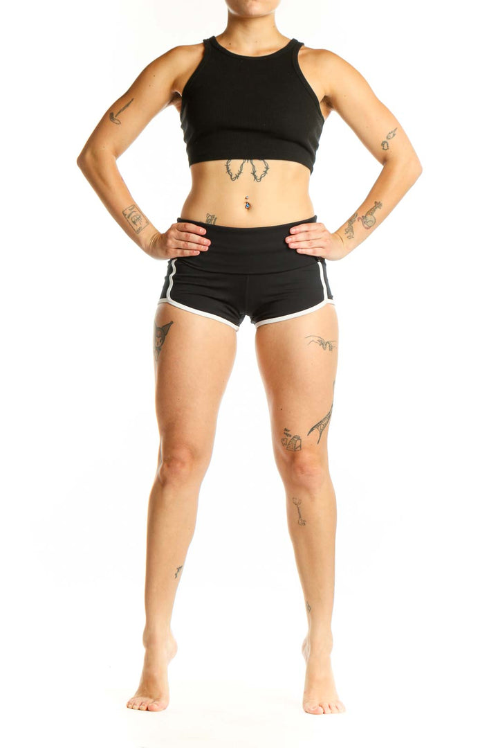Black activewear shorts with white trim, high-waisted design, front view on model