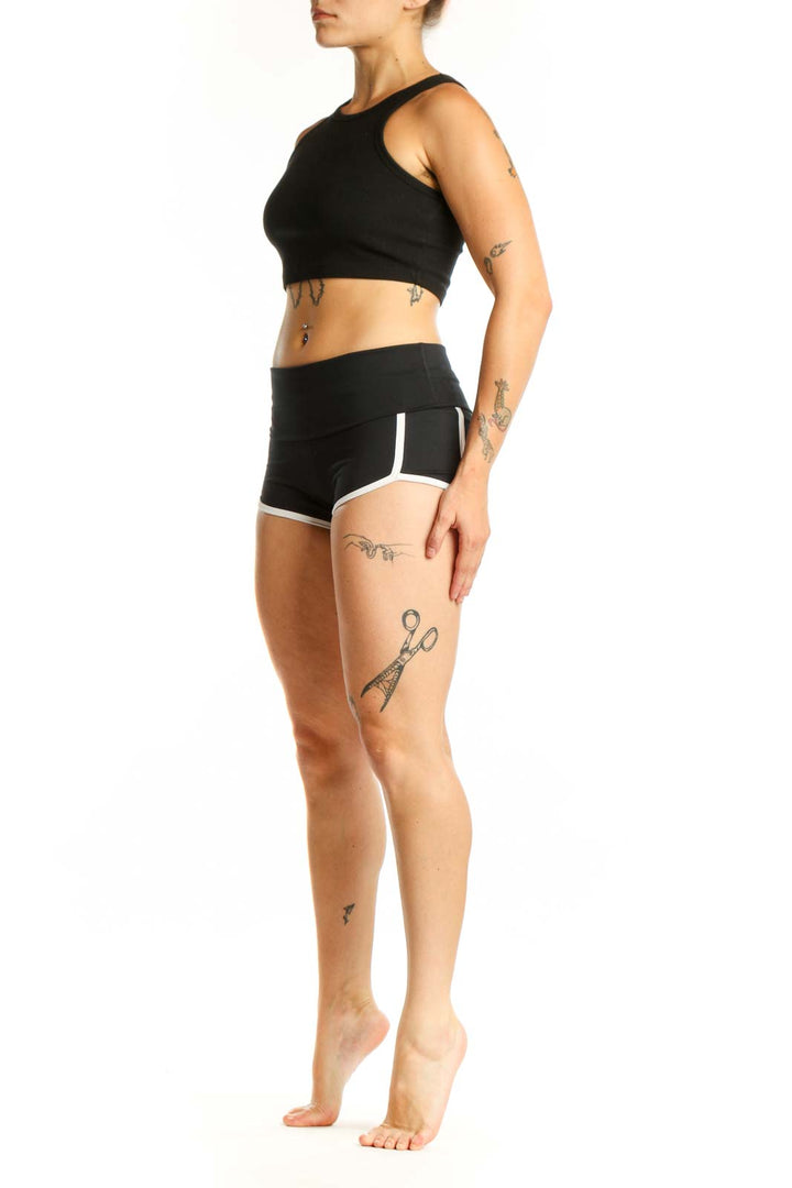 Black activewear shorts with white trim, high-waisted design, front view on model