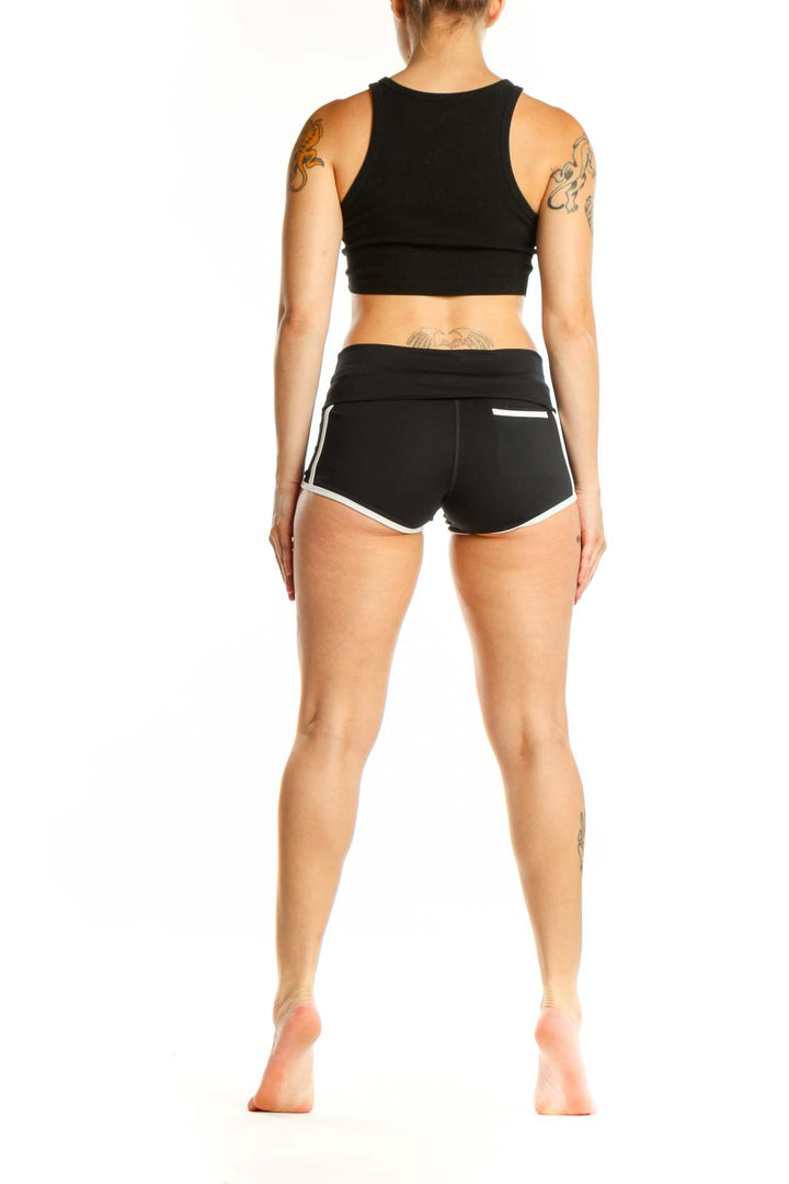Black activewear shorts with white trim, high-waisted design, back and side view on model