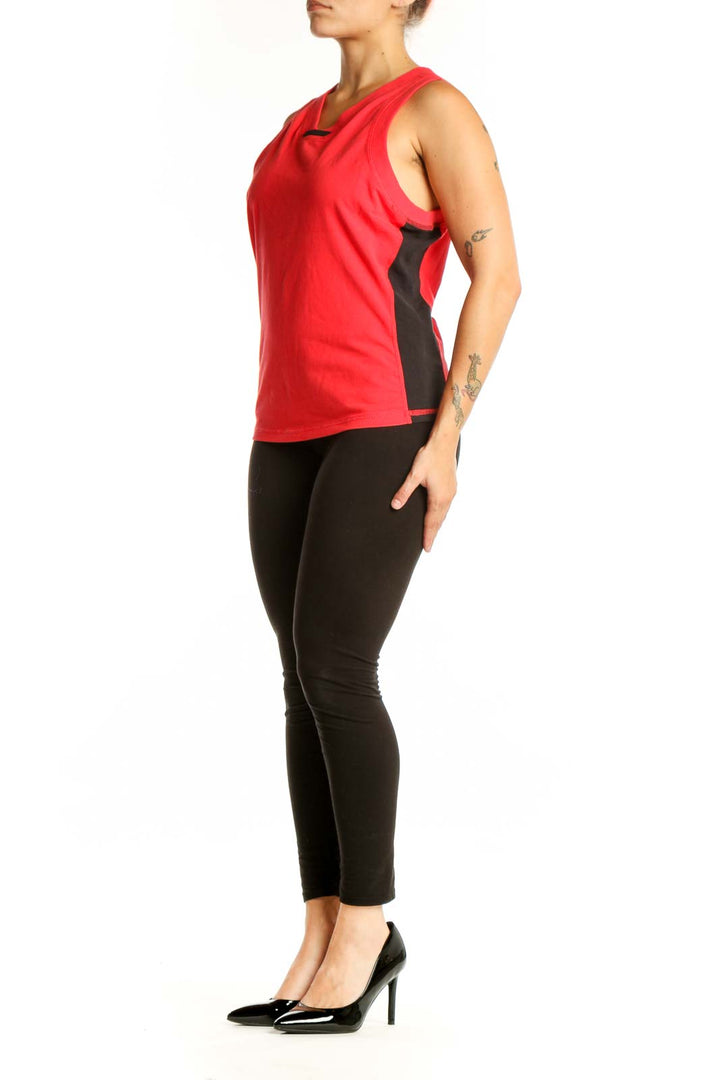 Red athletic tank top with V-neckline and black cutout detail, front view