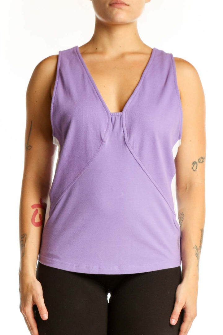 Purple V-neck activewear tank top with twisted front design, worn with black leggings