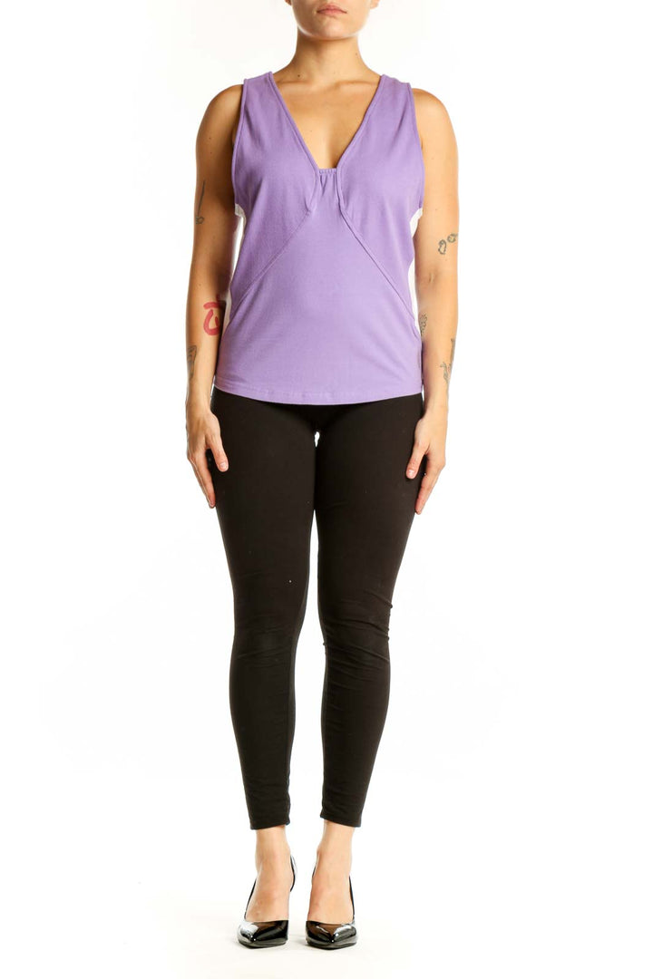 Purple V-neck activewear tank top with twisted front design, worn with black leggings