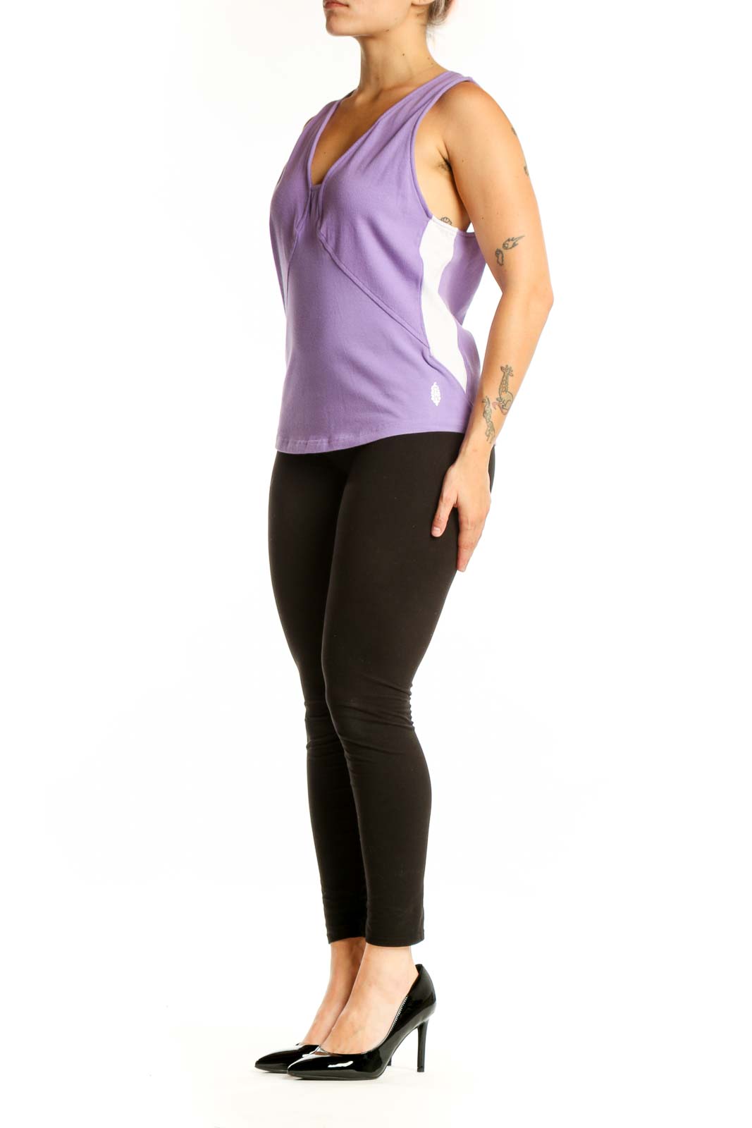 Purple V-neck activewear tank top with twisted front design, worn with black leggings