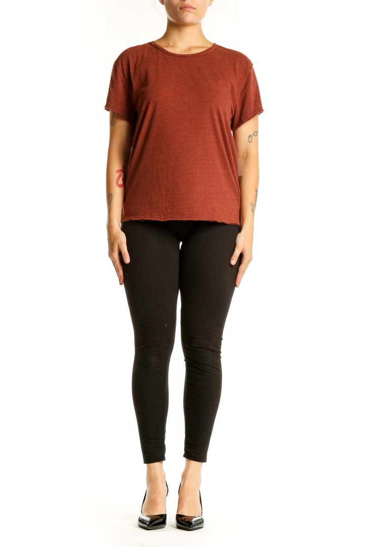 Rust organic cotton short sleeve crew neck tee by WE THE FREE, front view on model