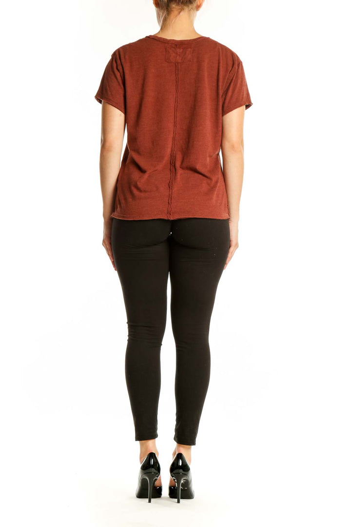 Rust organic cotton short sleeve tee by WE THE FREE, back view showing relaxed fit and distressed sleeve edges