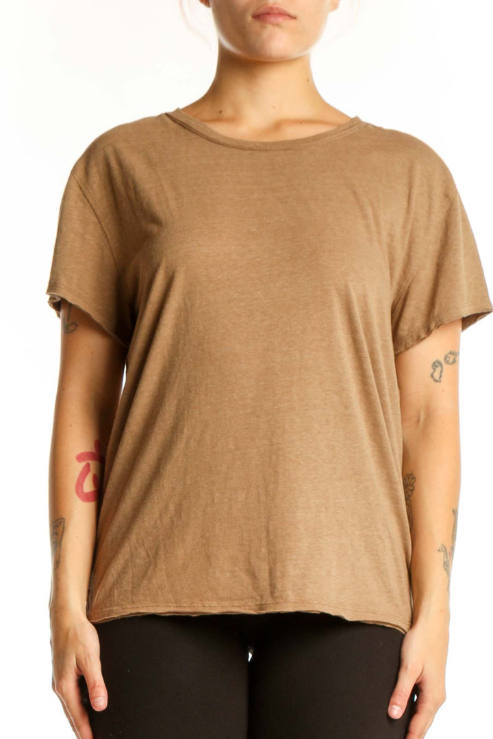 Woman wearing tan organic cotton crew neck t-shirt by WE THE FREE, front view