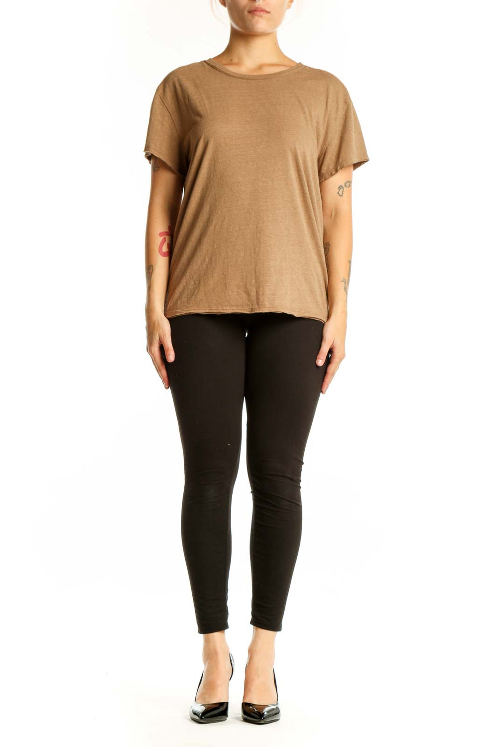 Woman wearing tan organic cotton crew neck t-shirt by WE THE FREE, front view