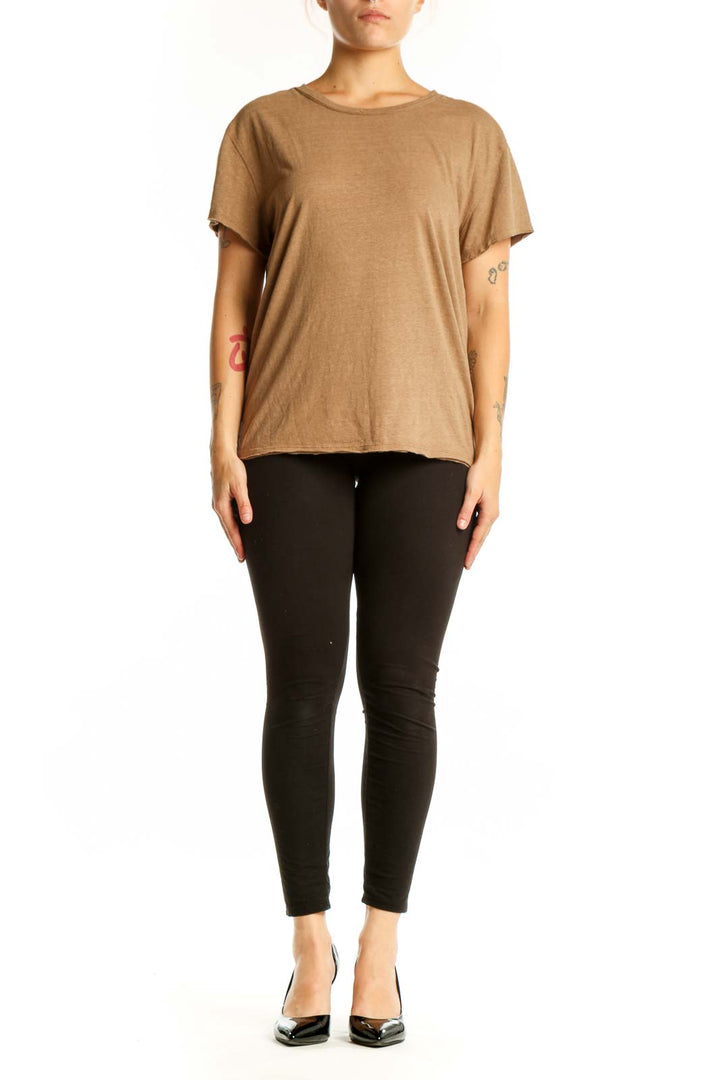 Woman wearing tan organic cotton crew neck t-shirt by WE THE FREE, front view