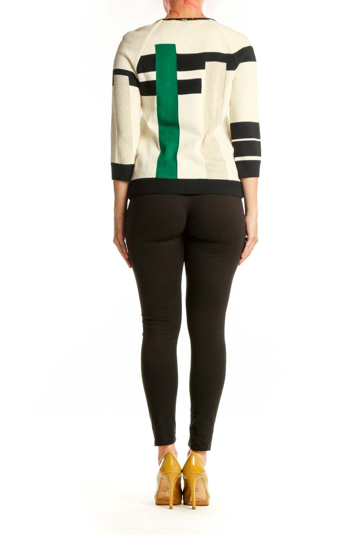 Back view of geometric knit cardigan showing color-block pattern in green, cream, and black with three-quarter sleeves