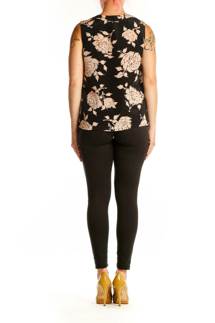 Black floral silk sleeveless top with cream and beige flower print, back view showing side profile