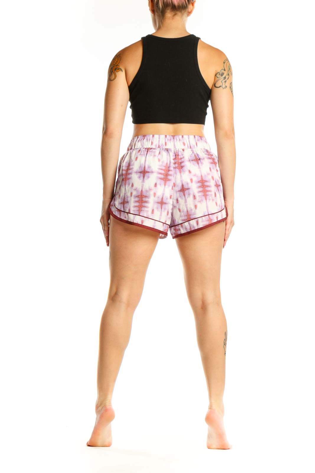 Back view of pink tie dye athletic shorts with burgundy trim and side pockets by Free People Movement