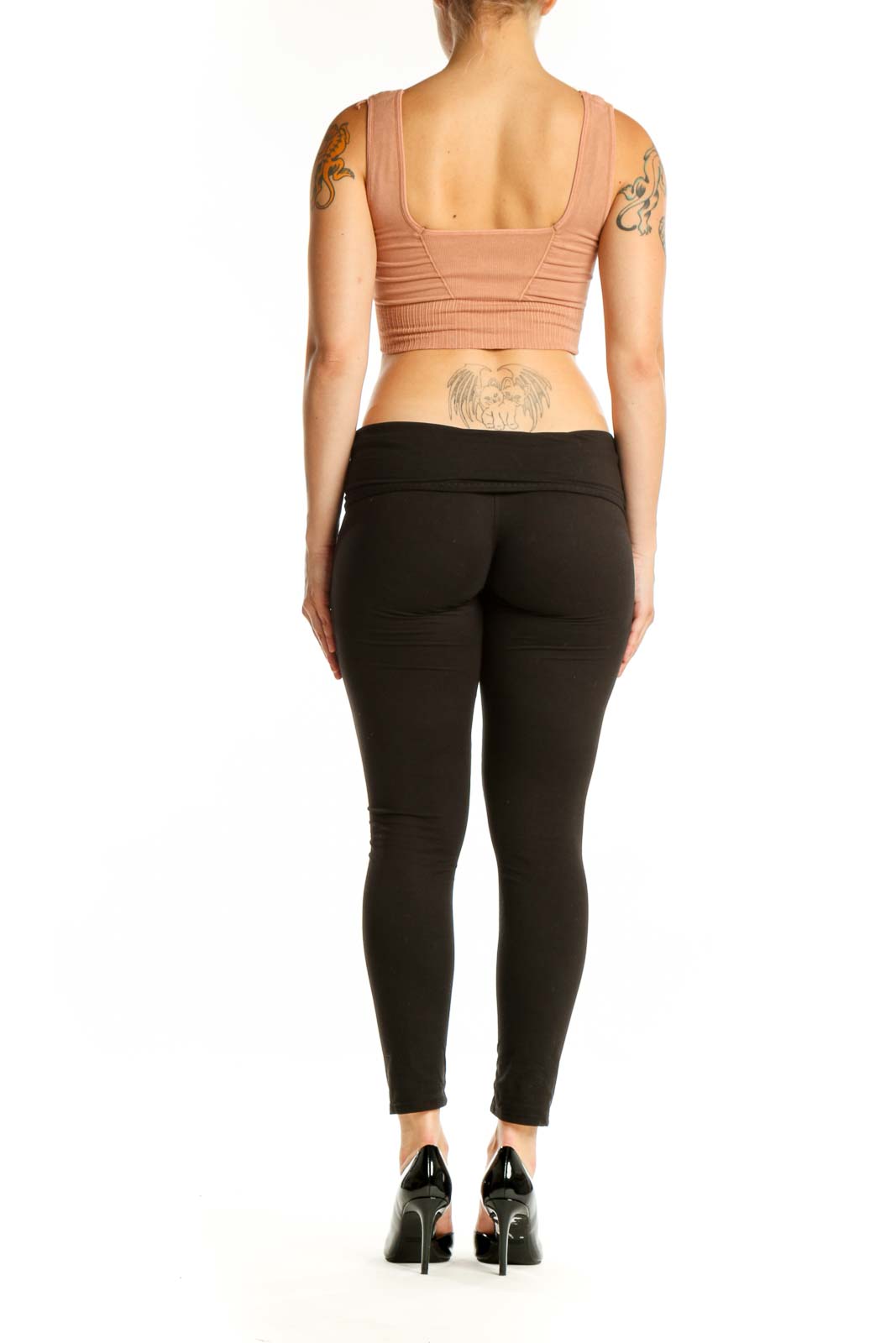 Beige ribbed crop top sports bra back view on model, showing fitted silhouette and ribbed texture detail